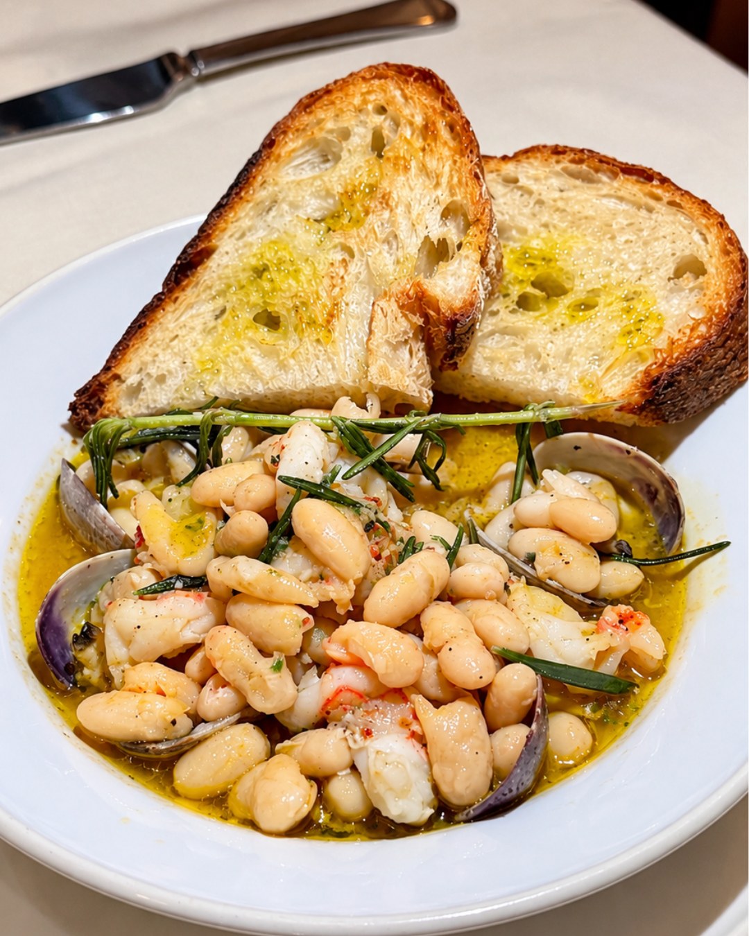 Cannellini beans with shrimp and clams, served with grilled bread