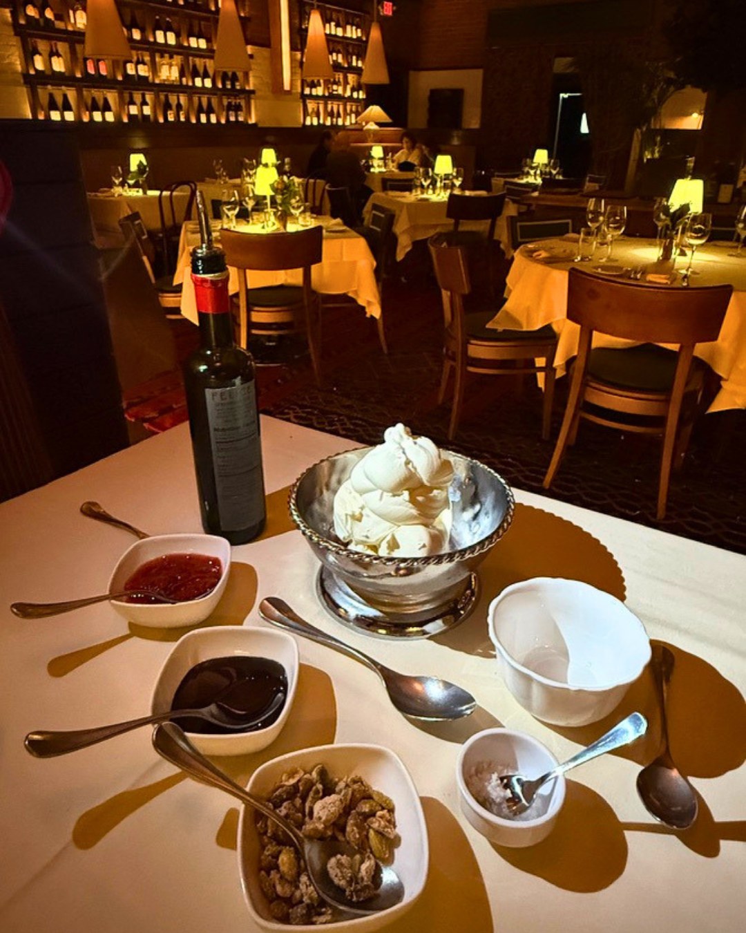 Felice signature gelato with compote, candied pistachios and toppings in the candlelit dining room