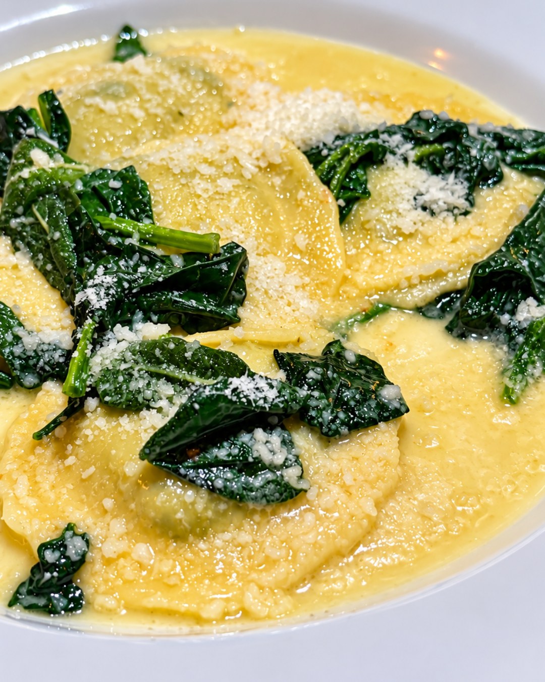 Ravioli della Casa filled with ricotta and spinach in butter and sage