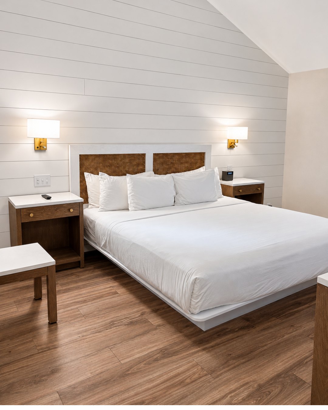 A spacious renovated guest room at Nantucket Inn with shiplap walls and a king bed