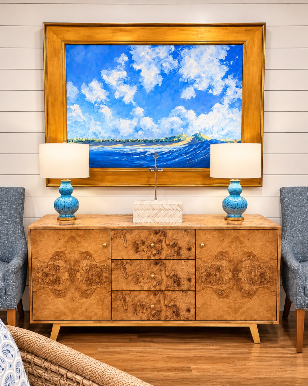 Coastal details at Nantucket Inn: an ocean painting, burl wood sideboard and blue ceramic lamps